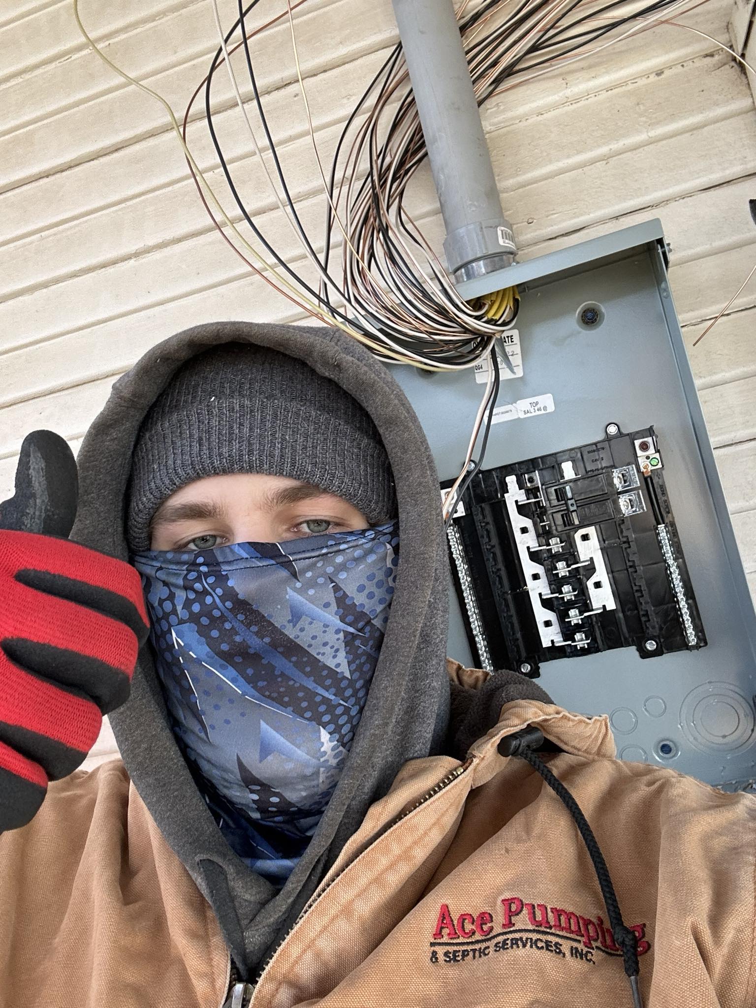 Electrician working on electrical panel in cold weather emergency service